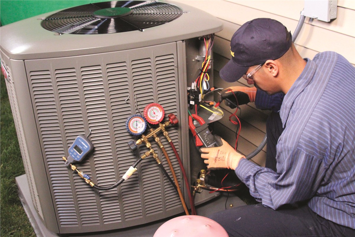 HVAC technician testing an outdoor air conditioning unit in Herriman